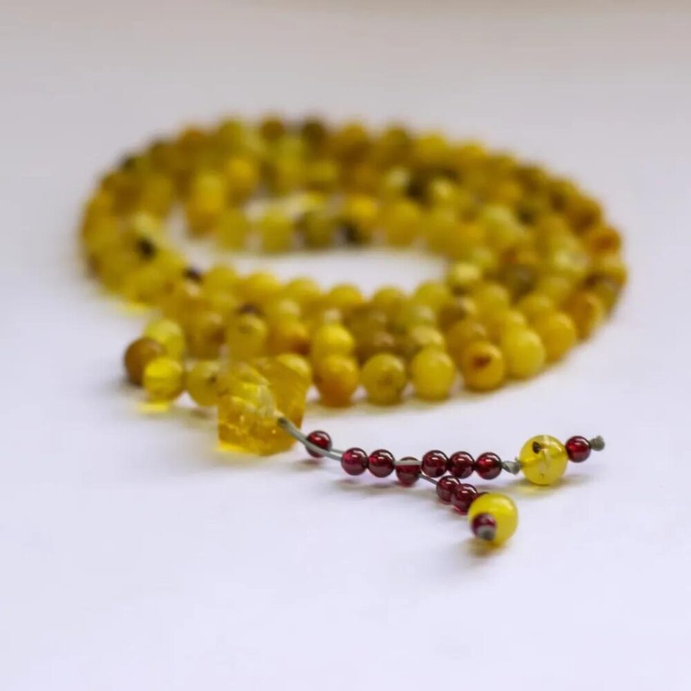 Amber Rosary - 100 Beads
with Citrine center piece and Garnet counter